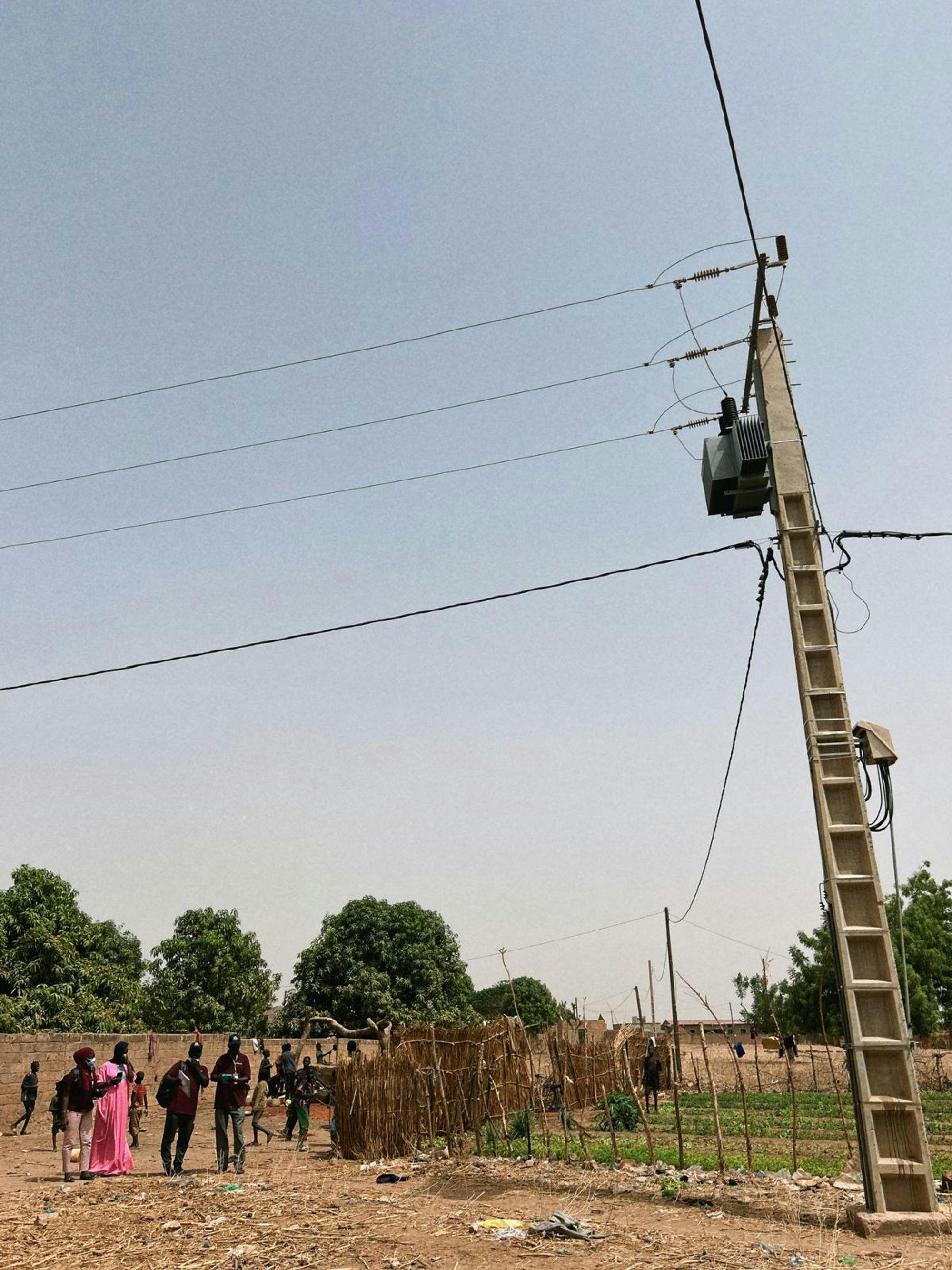 Arriving at a Community: The survey team locates the transformer in one of the 49 communities. From here, surveyors walk in three different directions - tracing one of the lines from the transformer - to locate a household and/or business for sensor installation. In each community, community guides (in pink, above) were present to introduce the surveyors to households and businesses. 