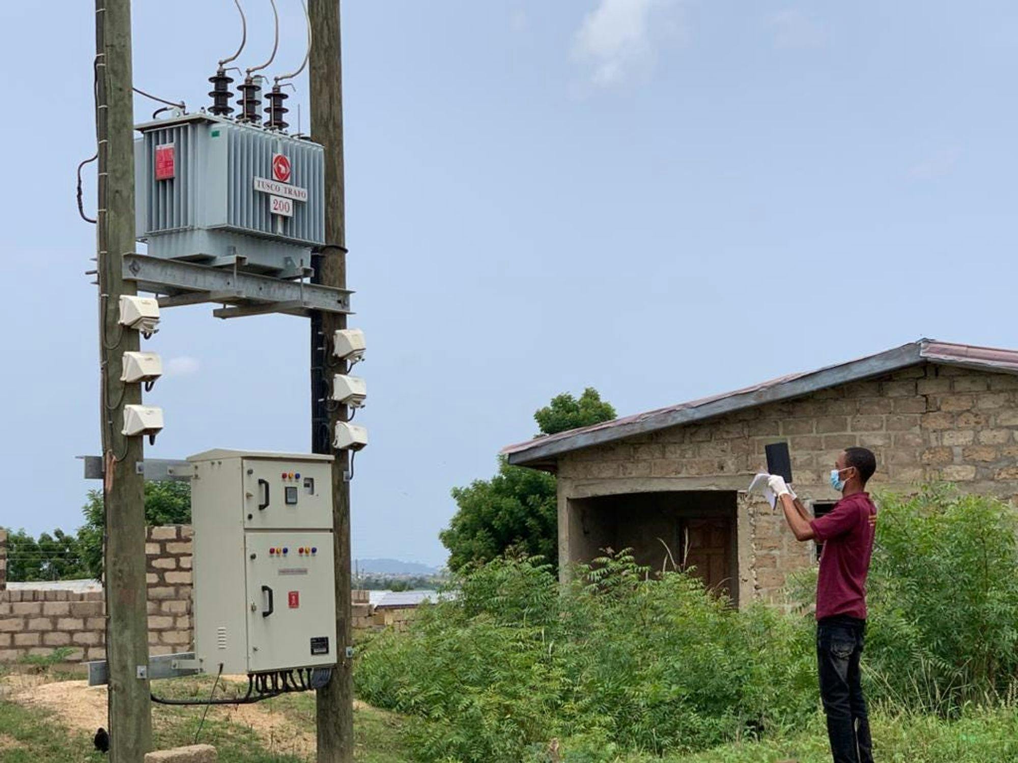 A Field Officer snaps a photo of a transformer (Photo credit: Daniel Essuah).