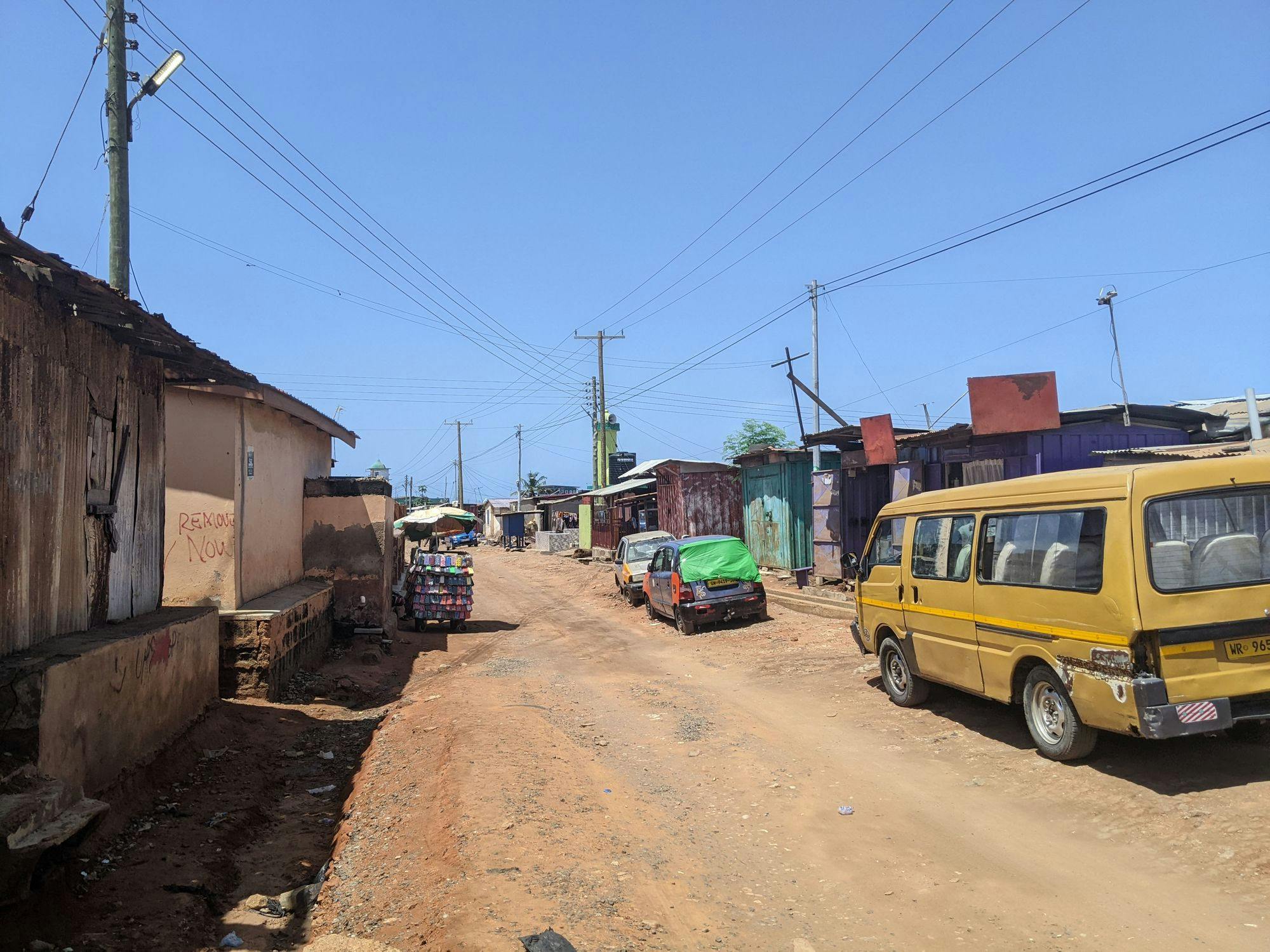 Figure 1. Pictured here is a street in Ablekuma, in the Dansoman district of Accra, Ghana. nLine’s SAIDI estimates for this region provide a picture of how the grid is serving this community. Data from many such communities can be aggregated to provide a comprehensive picture of system-wide grid performance. In this way, SAIDI values of varying spatial and temporal resolutions can give a utility key operational insights over time and space. At high resolutions — down to the individual distribution feeder level — SAIDI can help identify struggling feeders that would benefit from intervention, or well-performing feeders whose lessons can be applied elsewhere. At lower resolutions, SAIDI can reveal, for example, how large-scale infrastructure upgrades or widespread climate impacts are affecting grid service. (Photo credit: Molly Hickman)